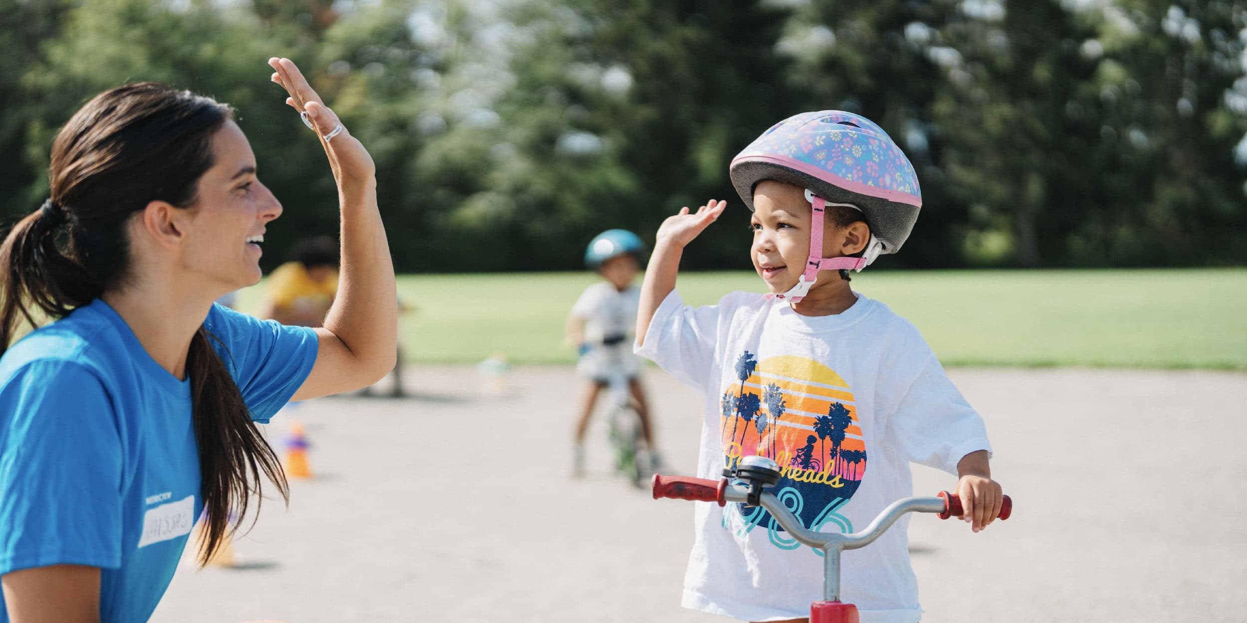 instructor high fiving girl at camp