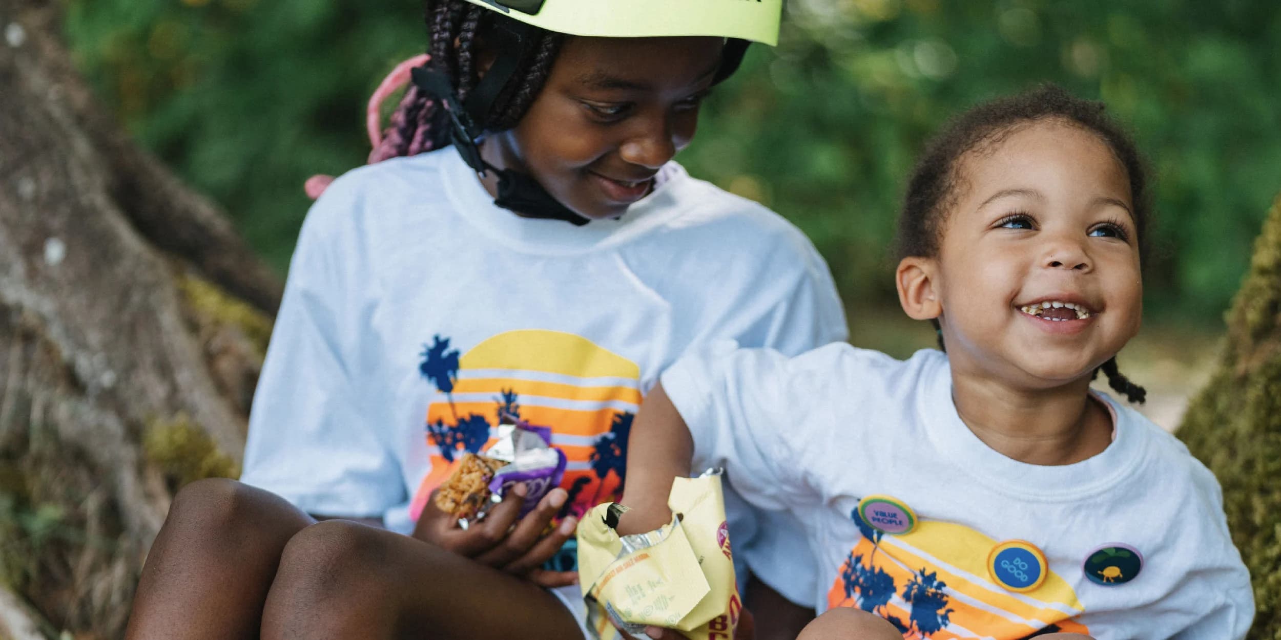 two young girls eating popcorn and smiling