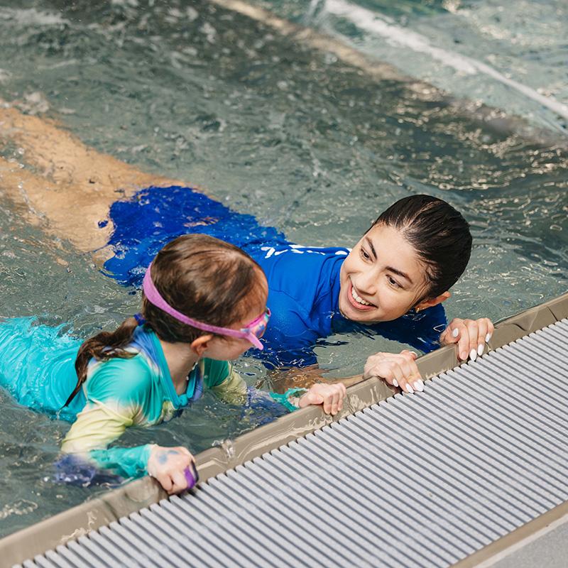 pedalheads swim instructor providing in water instruction with student