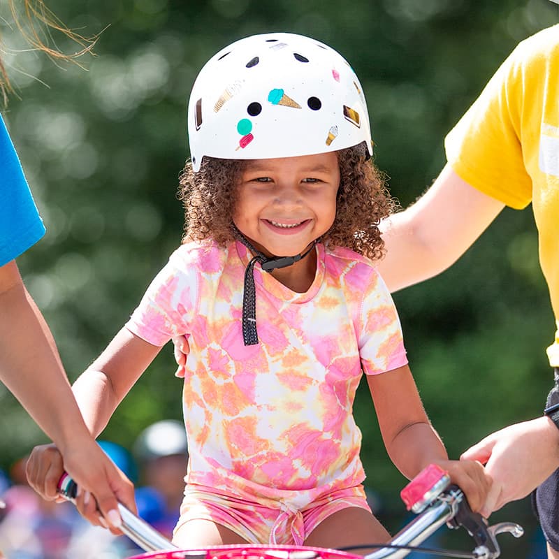 slider 3 girl learning to ride at bike camp in chicago illinois