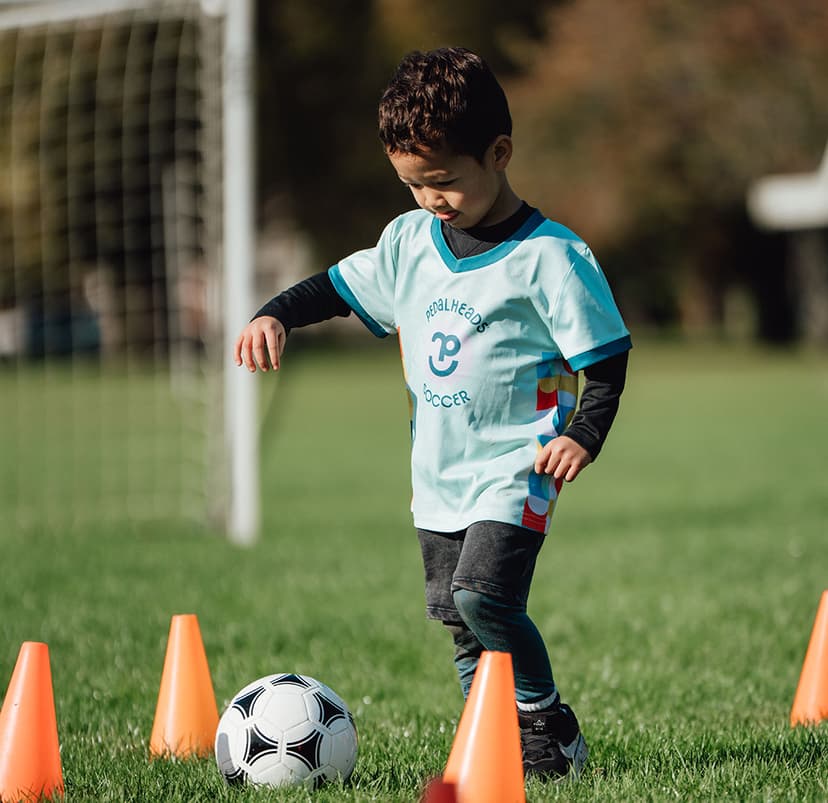 pedalheads soccer camper dribbling through cones